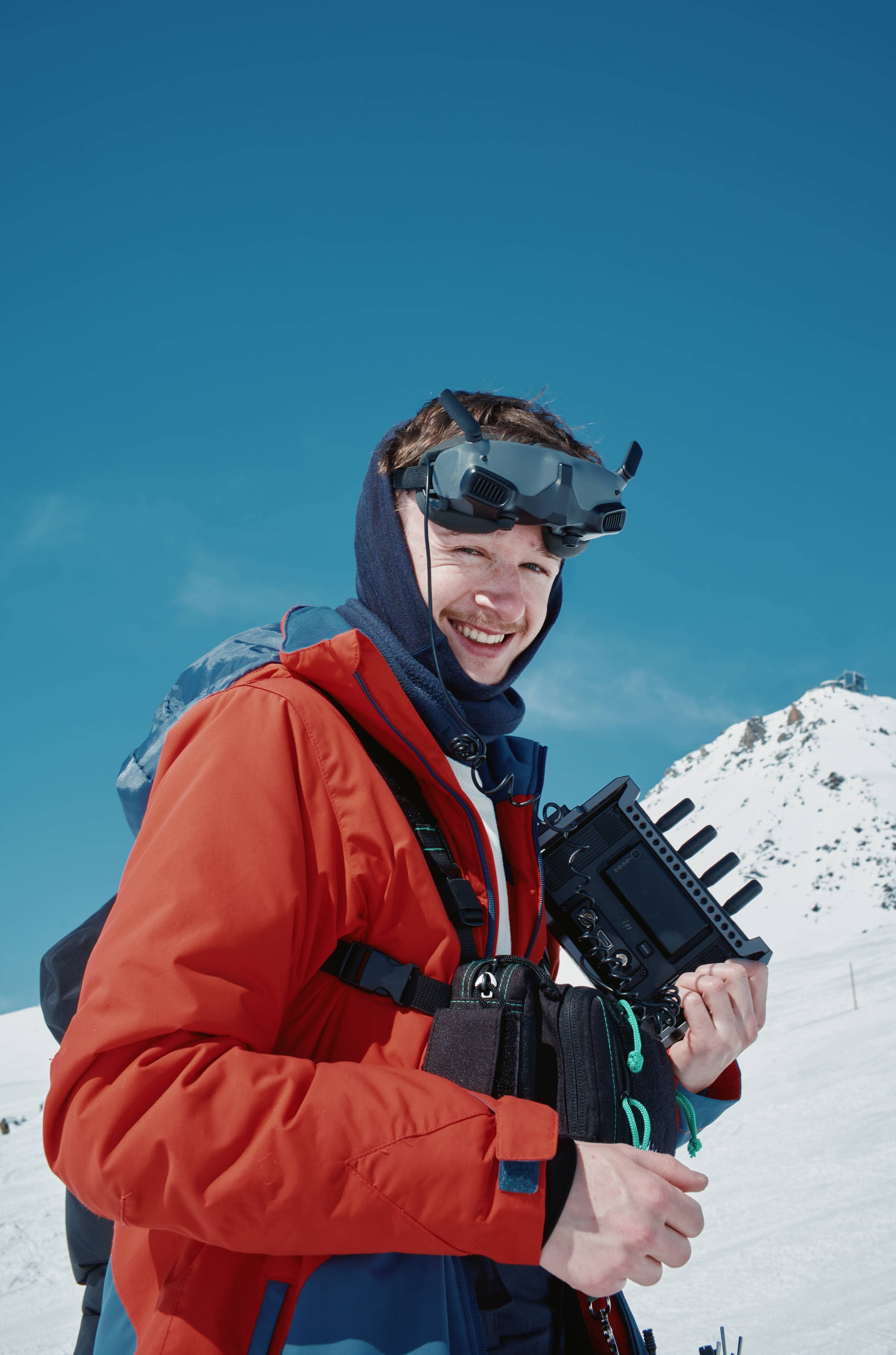 Noah Waldner Standing in front of a mountain, looking at the camera